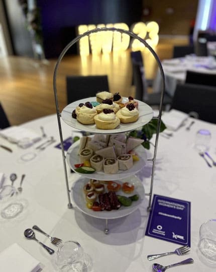 High tea stand with cakes and sandwiches